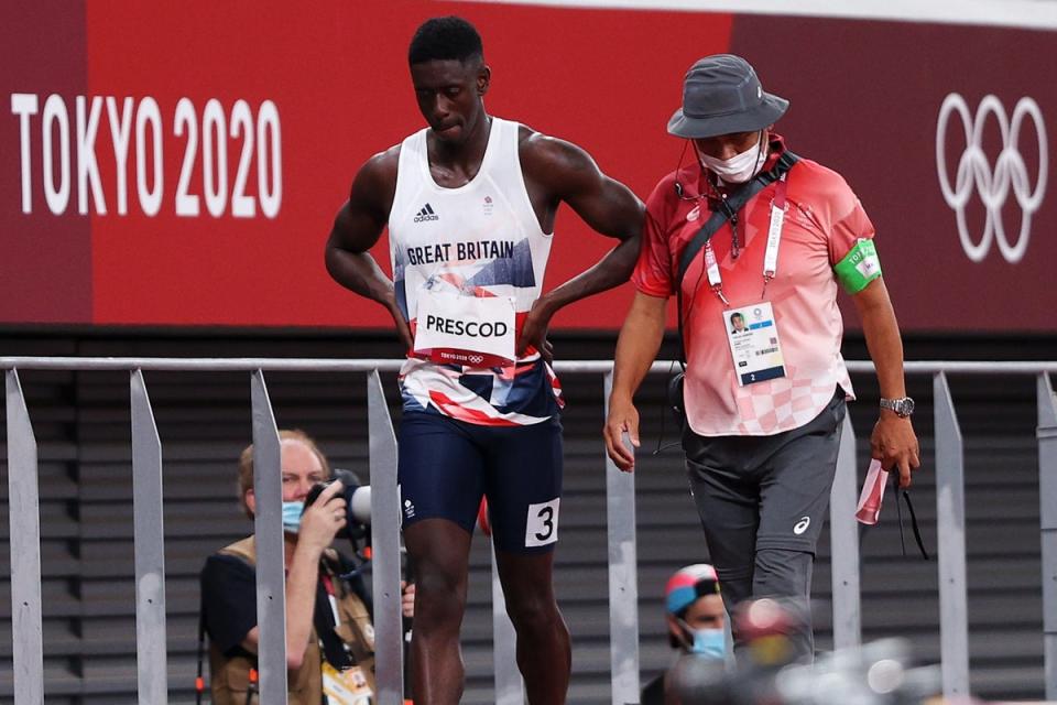 Prescod is accompanied from the track after his false start in Tokyo (Getty)