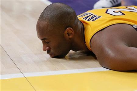 Los Angeles Lakers Kobe Bryant lies on the floor after being fouled during their NBA basketball game against the Toronto Raptors in Los Angeles March 8, 2013. REUTERS/Lucy Nicholson