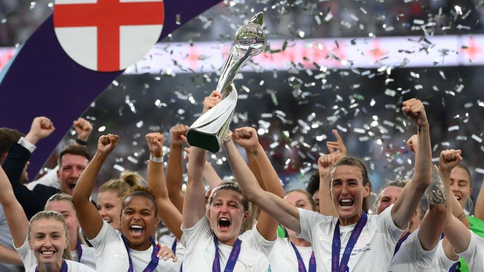 England's players celebrate with the trophy after their win in the UEFA Women's Euro 2022 final football match between England and Germany at the Wembley stadium, in London, on July 31, 2022. - England won a major women's tournament for the first time as Chloe Kelly's extra-time goal secured a 2-1 victory over Germany at a sold out Wembley on Sunday.