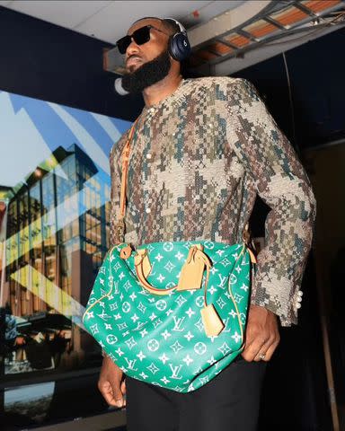 <p>LeBron James/Instagram</p> LeBron James snapped wearing a Louis Vuitton green leather speedy bag.