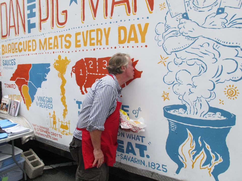 Dan Huntley, also known as "Dan the Pig Man" kisses the pig on his food truck in Charlotte, N.C. on Tuesday, Sept. 4, 2012. Huntley had his best day ever during the convention, selling $10,000 worth of barbecue sandwiches. (AP Photo/Jeffrey Collins)