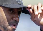 Retired NBA All-Star Tracy McGrady adjusts his cap before a workout at the Sugar Land Skeeters baseball stadium Wednesday, Feb. 12, 2014, in Sugar Land, Texas. McGrady hopes to tryout as a pitcher for the independent Atlantic League Skeeters. (AP Photo/Pat Sullivan)