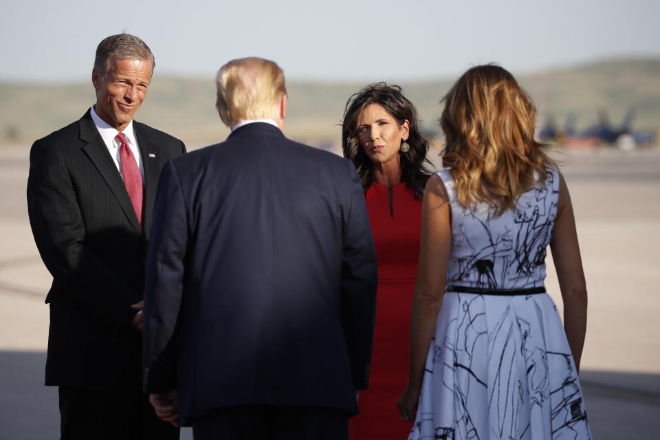 Sen. John Thune, R-S.D., and South Dakota Gov. Kristi Noem greet President Donald Trump and first lady Melania Trump upon arrival at Ellsworth Air Force Base on July 3 in Rapid City, S.D., en route to Mount Rushmore.