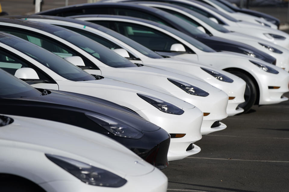 A long row of unsold 2021 Model 3 sedans sits at a Tesla dealership Sunday, Dec. 27, 2020, in Littleton, Colo. (AP Photo/David Zalubowski)