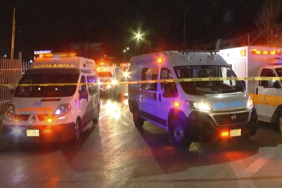 Image taken from a video showing ambulances and rescue teams staffers outside an immigration center in Ciudad Juarez, Mexico, Tuesday, March 28, 2023. At least three dozen migrants have died in a fire at an immigration detention center in northern Mexico near the U.S. border, according to a newspaper report. Images from the scene showed rows of bodies lying under shimmery silver sheets outside the facility in Ciudad Juarez, across from El Paso, Texas. Ambulances, firefighters and vans from the morgue could also be seen. (AP Photo)