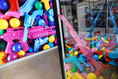 A toy gun claw machine is seen as part of an art installation by artist WhIsBe titled "Back to School Shopping" to illustrate the dangers of gun violence in schools, at a gallery in New York City