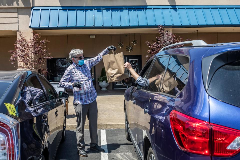 Jim Hagy, owner of Chef&#39;s Market in Goodlettsville, delivers curbside pickup orders from his restaurant Monday, May 4, 2020.