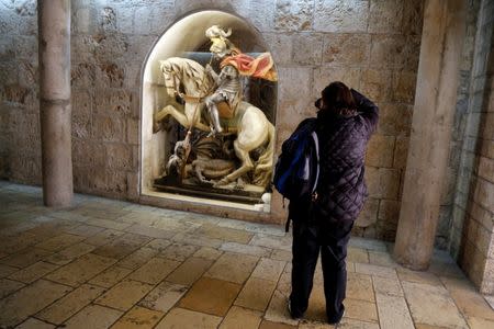 A tourist takes a picture at the Church of the Nativity in Bethlehem in the occupied West Bank, December 10, 2018. REUTERS/Raneen Sawafta