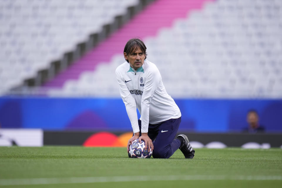Inter Milan's head coach Simone Inzaghi kneels on the ball during a training session at the Ataturk Olympic Stadium in Istanbul, Turkey, Friday, June 9, 2023. Manchester City and Inter Milan are making their final preparations ahead of their clash in the Champions League final on Saturday night. (AP Photo/Manu Fernandez)
