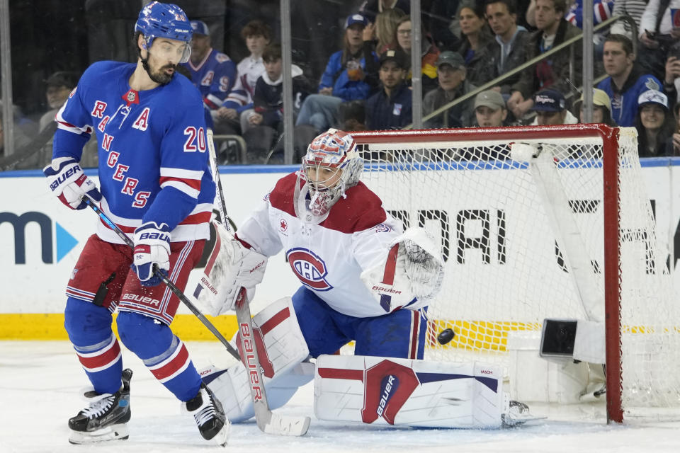 New York Rangers left wing Chris Kreider (20) scores past Montreal Canadiens goaltender Cayden Primeau, right, during the third period of an NHL hockey game, Sunday, April 7, 2024, at Madison Square Garden in New York. (AP Photo/Mary Altaffer)