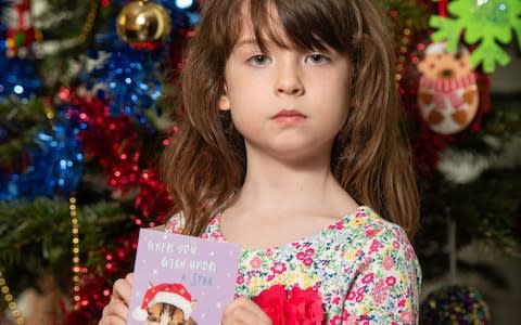 Florence Widdicombe holding a Tesco Christmas card - Credit: Dominic Lipinski/PA