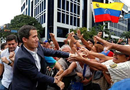 Juan Guaido, President of Venezuela's National Assembly, greets supporters during a rally against Venezuelan President Nicolas Maduro's government and to commemorate the 61st anniversary of the end of the dictatorship of Marcos Perez Jimenez in Caracas, Venezuela January 23, 2019. REUTERS/Carlos Garcia Rawlins