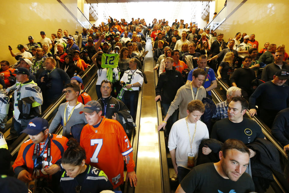 Football fans make their way to trains on Sunday, Feb. 2, 2014, in Secaucus, N.J. The Seattle Seahawks are scheduled to play the Denver Broncos in NFL football's Super Bowl XLVIII game on Sunday evening at MetLife Stadium in East Rutherford, N.J. (AP Photo/Matt Rourke)