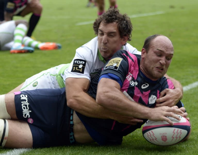 Stade Francais' flanker Antoine Burban (front) scores a try during their French Top 14 rugby union match against Pau, at the Jean-Bouin stadium in Paris, on August 23, 2015