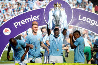 <p>Soccer Football – Premier League – Manchester City vs Huddersfield Town – Etihad Stadium, Manchester, Britain – May 6, 2018 Manchester City’s Benjamin Mendy celebrates with the trophy after winning the Premier League title REUTERS/Phil Noble EDITORIAL USE ONLY. No use with unauthorized audio, video, data, fixture lists, club/league logos or “live” services. Online in-match use limited to 75 images, no video emulation. No use in betting, games or single club/league/player publications. Please contact your account representative for further details. </p>