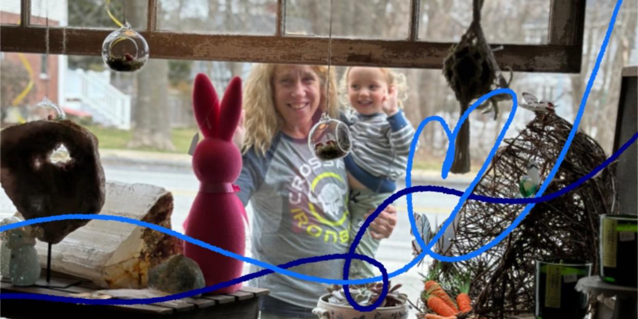 Barb Higgins is pictured looking through a shop window and holding her son.