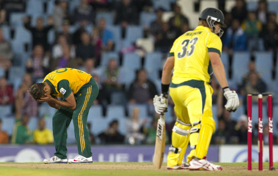South Africa's bowler Imran Tahir, left, reacts after his delivery against Australia's batsman Shane Watson, right, during their T20 Cricket match at Centurion Park in Pretoria, South Africa, Friday, March 14, 2014. (AP Photo/Themba Hadebe)