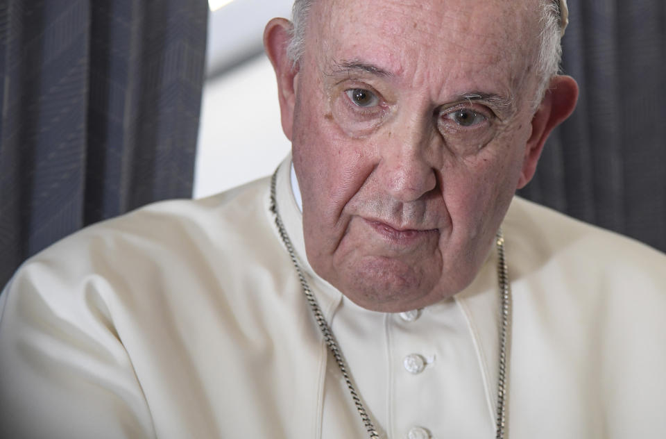 Pope Francis greets the journalists onboard the papal plane on the occasion of his five-day pastoral visit to Cyprus and Greece, Monday, Dec. 6, 2021. Francis' five-day trip to Cyprus and Greece has been dominated by the migrant issue and Francis' call for European countries to stop building walls, stoking fears and shutting out "those in greater need who knock at our door." (Alessandro Di Meo/Pool photo via AP)