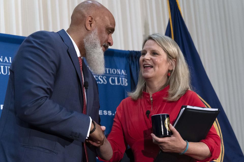 Executive Director of the Major League Baseball Players Association Tony Clark shakes hands with AFL-CIO President Liz Shuler during a news conference at the Press Club in Washington, Wednesday, Sept. 7, 2022. (AP Photo/Jose Luis Magana)