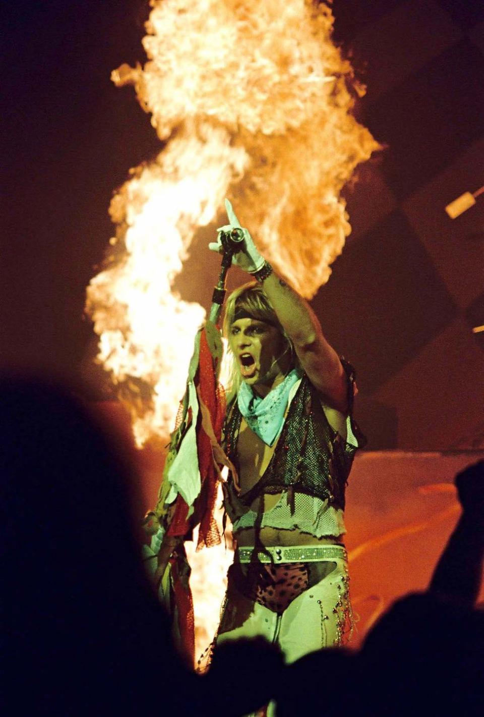 <p>Neil performing with a plume of fire behind him (a popular stage component for them) at the Hammersmith Odeon in London in 1986. </p>