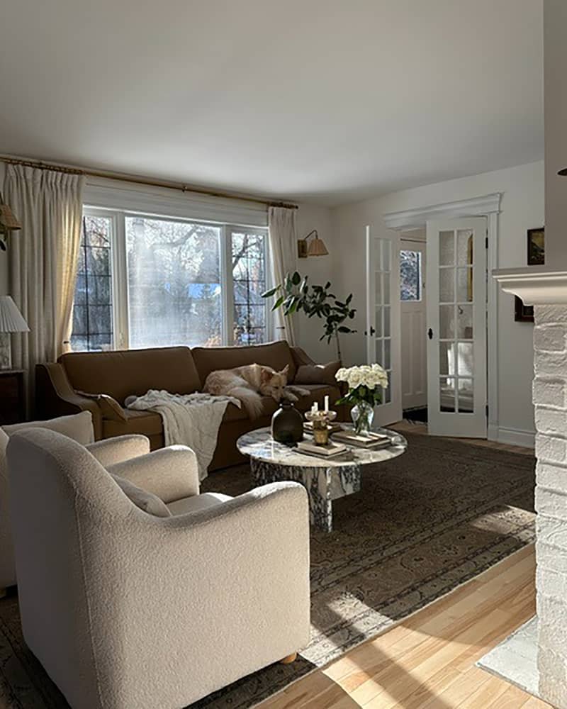 Natural light streaming into neutral toned living room.