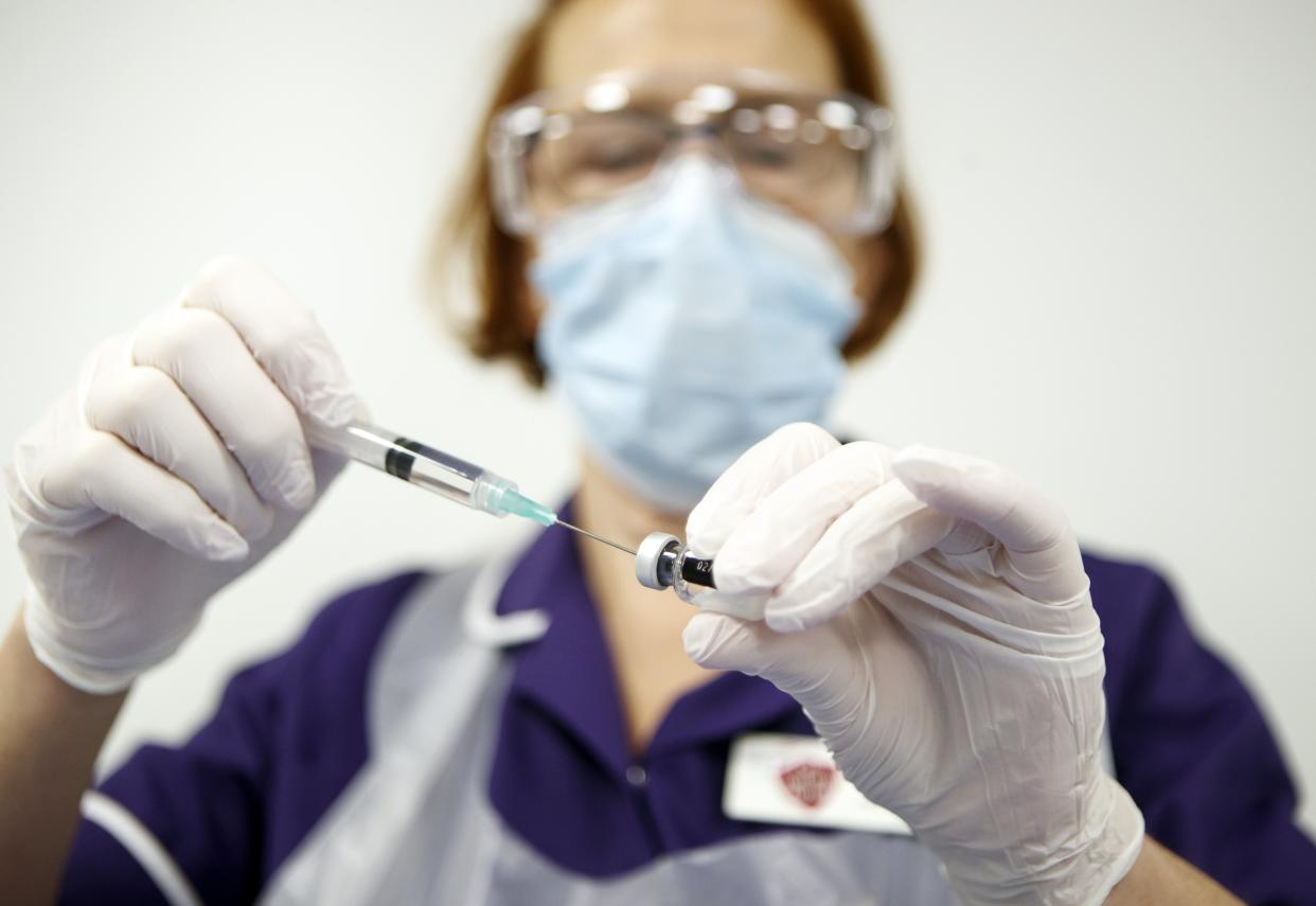 <p>Nurse Pat Sugden prepares the Pfizer-BioNTech vaccine at the Thackray Museum of Medicine in Leeds</p> (PA)