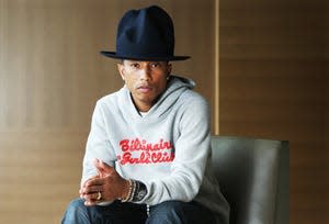 American musician Pharrell Williams poses in a gray hoodie and black mountain hat during a photo shoot at the Park Hyatt Hotel on March 6, 2014 in Sydney, Australia.