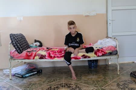 A Yazidi boy, twelve year-old Imad Tammo rescued from Islamic State militants by the Iraqi army, is seen in Sina neighbourhood outside of Duhok, Iraq July 25, 2017. REUTERS/Ari Jalal