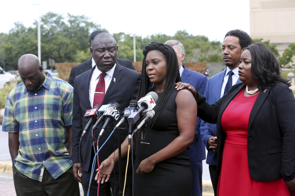 Britany Jacobs, center, speaks on behalf of her boyfriend, Markeis McGlockton, flanked by attorney Benjamin Crump, left, and Clearwater attorney Michele Rayner, right, while speaking to the media at the Pinellas County Criminal Justice Center Thursday, July 26, 2018, in Clearwater, Fla. McGlockton an unarmed black man was fatally shot outside a Clearwater convenience store on July 19. (Douglas R. Clifford/Tampa Bay Times via AP)