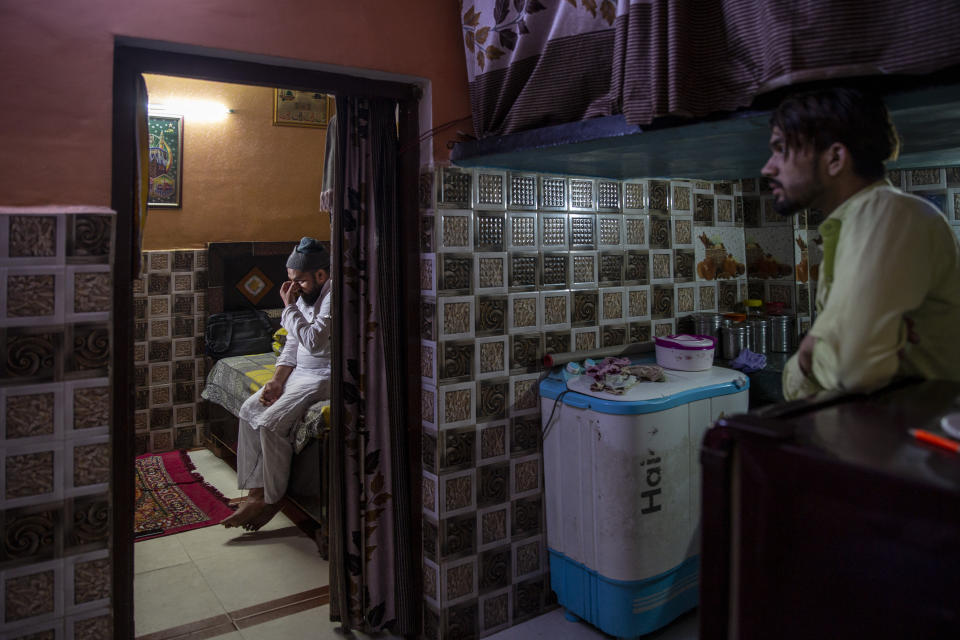 Haroon, left, who saw his 32 year-old brother being shot and killed by his Hindu neighbors during the February 2020 communal riots, breaks down while speaking to the Associated Press inside his home in North Ghonda, one of the worst riot affected neighborhood, in New Delhi, India, Friday, Feb. 19, 2021. As the first anniversary of bloody communal riots that convulsed the Indian capital approaches, Muslim victims are still shaken and struggling to make sense of their struggle to seek justice. (AP Photo/Altaf Qadri)