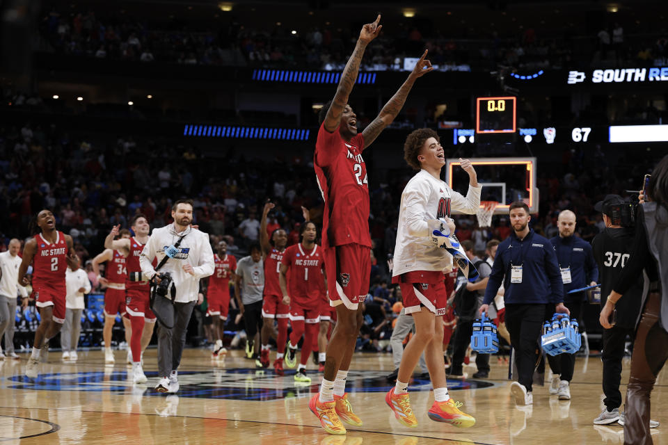 North Carolina State's Ernest Ross (24) and teammates react after defeating Marquette 67-58 in a Sweet 16 college basketball game in the NCAA Tournament in Dallas, Friday, March 29, 2024. (AP Photo/Brandon Wade)