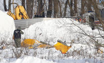 <p>A man looks at wreckage near the scene of a AN-148 plane crash in Stepanovskoye village, about 40 kilometers (25 miles) from the Domodedovo airport, Russia, Feb. 12, 2018. (Photo: Alexander Zemlianichenko/AP) </p>