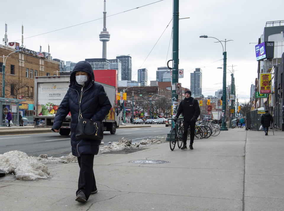 A pedestrian wears a protective mask in Toronto on Monday.