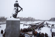 People walk in snowfall to the Motherland monument to put flowers at the Piskaryovskoye Cemetery where most of the Leningrad Siege victims were buried during World War II, in St.Petersburg, Russia, Saturday, Jan. 26, 2019. People gather to mark the 75th anniversary of the battle that lifted the Siege of Leningrad. The Nazi German and Finnish siege and blockade of Leningrad, now known as St. Petersburg, was broken on Jan. 18, 1943 but finally lifted Jan. 27, 1944. More than 1 million people died mainly from starvation during the 900-day siege. (AP Photo/Dmitri Lovetsky)