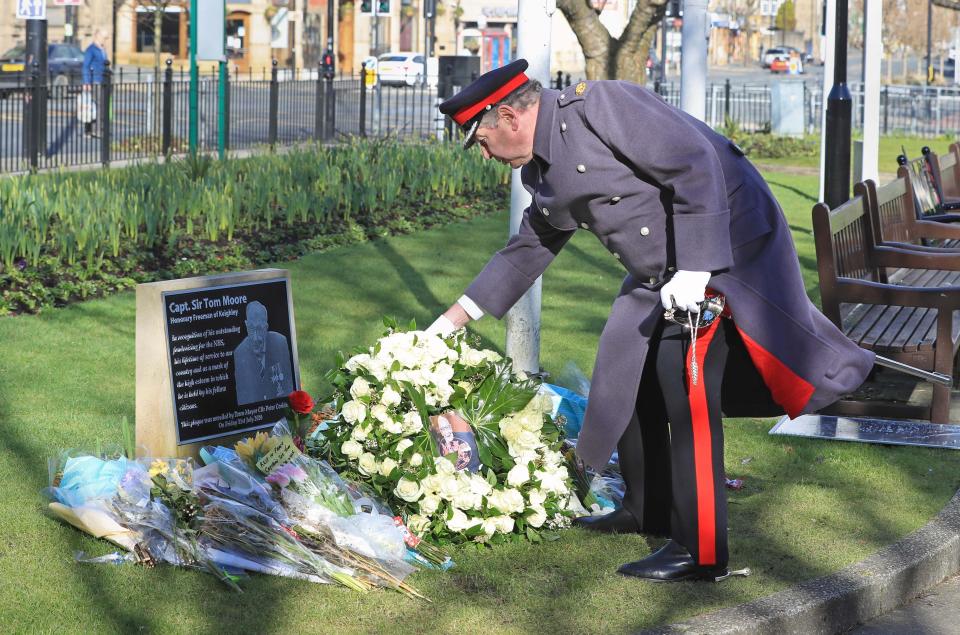 David Pearson, Deputy Lieutenant for West Yorkshire lays a wreath of 200 white roses at the Sir Tom Moore memorial plaque in Keighley, West Yorkshire, on the day of Captain Sir Tom Moore's funeralPA