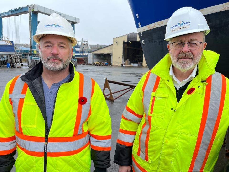 Wayne Reid, left, and Paul Lannon run things at the Harbour Grace Ocean Enterprises shipyard. For now, it's business as usual at the yard, but the company has fallen on hard financial times and creditors are being kept at bay by the Supreme Court as the owners try to restructure and salvage the business. (Terry Roberts/CBC - image credit)