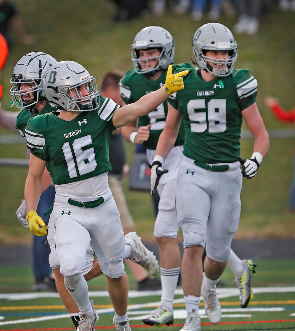 Dragon Adam Barr signals to fans in the end zone after scoring in the first half.The Duxbury Dragons hosted the Middleboro Sachems in MIAA football tournament action on Friday November 11, 2022.