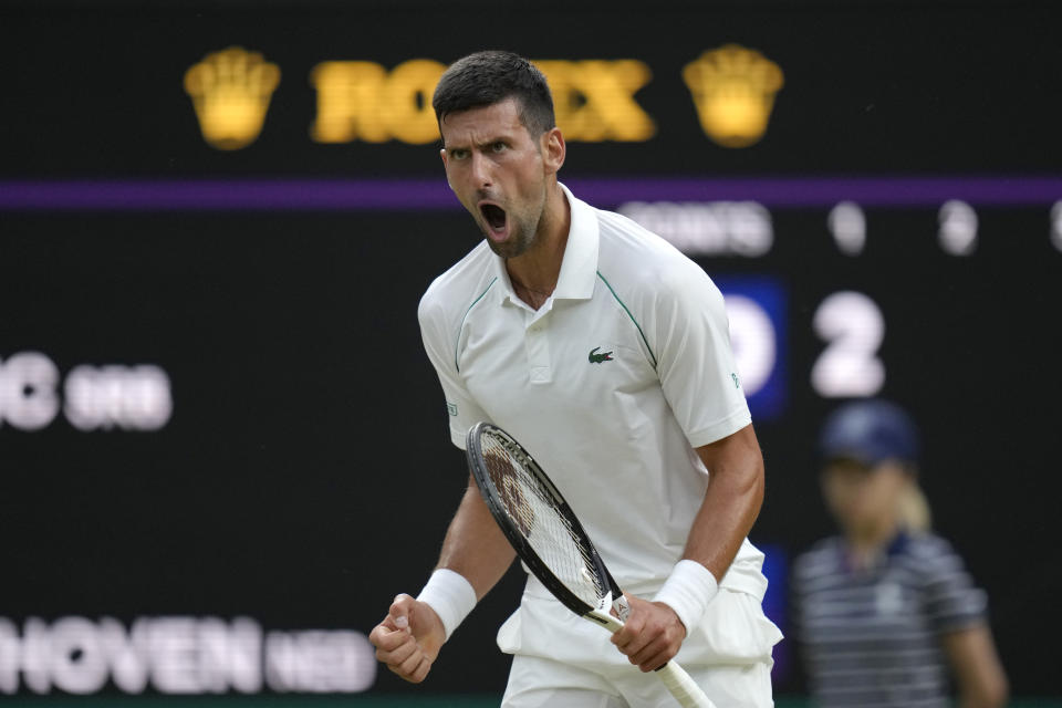 Serbia's Novak Djokovic celebrates winning a point against Tim van Rijthoven of the Netherlands during a men's fourth round singles match on day seven of the Wimbledon tennis championships in London, Sunday, July 3, 2022.(AP Photo/Kirsty Wigglesworth)