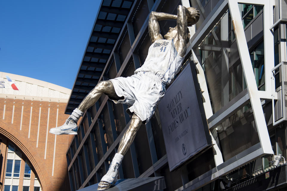 Dirk Nowitzki's statue is unveiled during the "All Four One" statue ceremony in front of the American Airlines Center in Dallas, Sunday, Dec. 25, 2022. (AP Photo/Emil T. Lippe)1