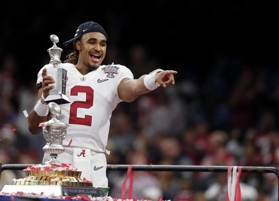 Jalen Hurts holds up his most valuable offensive player trophy after defeating Clemson in the Sugar Bowl. (AP)