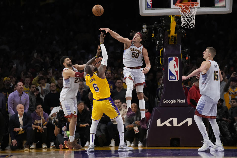 Los Angeles Lakers forward LeBron James (6) misses a layup attempt between Denver Nuggets forward Aaron Gordon (50) and guard Jamal Murray, left, as time expired in the second half of Game 4 of the NBA basketball Western Conference Final series Monday, May 22, 2023, in Los Angeles. Denver won 113-111 to win the series. (AP Photo/Ashley Landis)