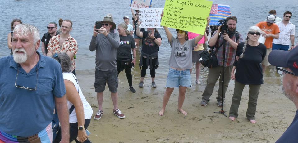 Protesters fill in Ropes Beach as they chant, "Shame" over and over in the direction of an outdoor reception at 51 Putnam Ave as Florida Governor and GOP presidential hopeful Ron DeSantis made a fundraising stop in Cotuit on Saturday. 
Cape Cod Times/Steve Heaslip