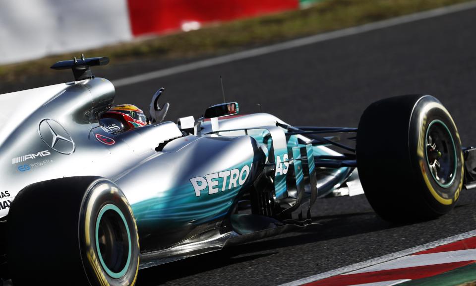 <p>Lewis Hamilton celebrates as he returns to the pits after winning the Japanese Grand Prix at Suzuka.</p>