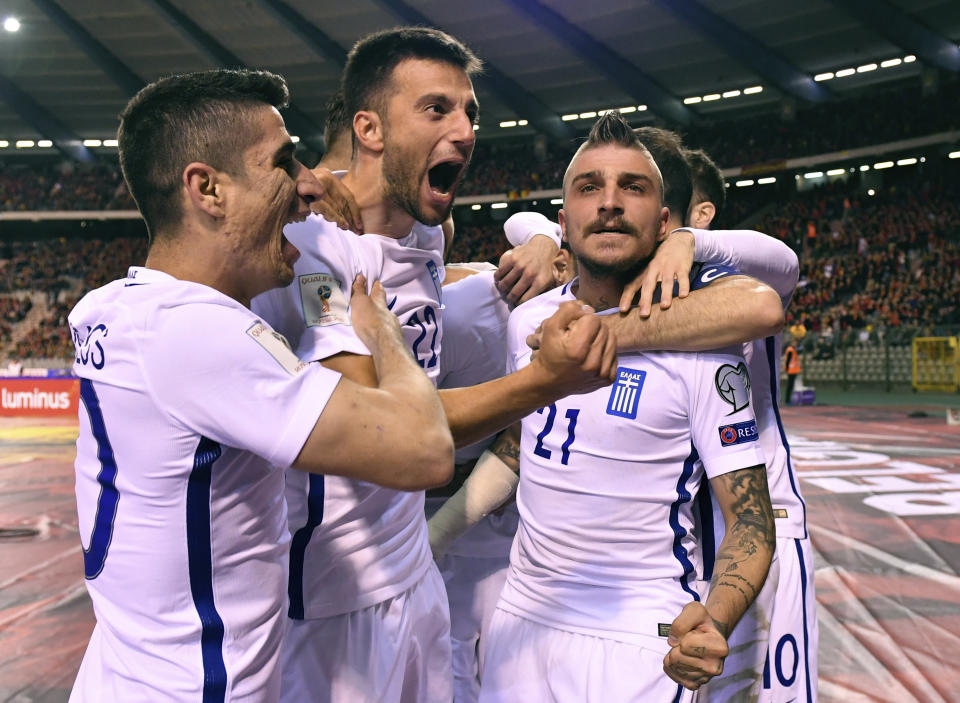 Greece's Andreas Samaris, center, celebrates with team mates after Greece scored a first match goal during the Euro 2018 Group H qualifying match between Belgium and Greece at the King Baudouin stadium in Brussels on Saturday, March 25, 2017. (AP Photo/Geert Vanden Wijngaert)