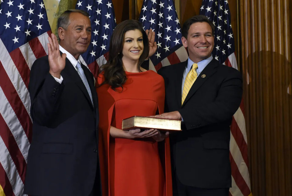 Newly elected U.S. Rep. Ron DeSantis, right, takes the oath of office in January 2012, with his wife Casey holding a Bible and House Speaker John Boehner.