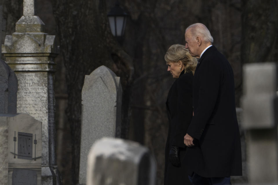 President Joe Biden and first lady Jill Biden walk between tombstones to attend Mass at St. Joseph on the Brandywine Catholic Church in Wilmington, Del., on Sunday, Dec. 18, 2022. Sunday marks the 50th anniversary of the car crash that killed Biden's first wife Neilia Hunter Biden and 13-month-old daughter Naomi. (AP Photo/Manuel Balce Ceneta)