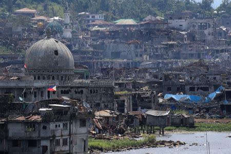 Damaged buildings beside a mosque are seen after government troops cleared the area from pro-Islamic State militant groups inside a war-torn area in Marawi city, southern Philippines October 23, 2017. REUTERS/Romeo Ranoco