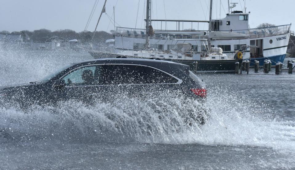 At Ocean Street in Hyannis, sea water flooded onto the roadway at the time of the Friday morning high tide, coating passing motorists with salt water.