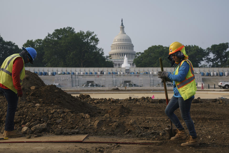 FILE - In this July 21, 2021, file photo workers repair a park near the Capitol in Washington. Senators working on the infrastructure plan hope to have a bill ready to be voted on next week. President Joe Biden has made passing the bipartisan plan a top priority, the first of his two-part $4 trillion proposal to rebuild, but a Senate test vote failed this week after Republicans said they needed more time to finish the package and review the details. (AP Photo/J. Scott Applewhite, File)