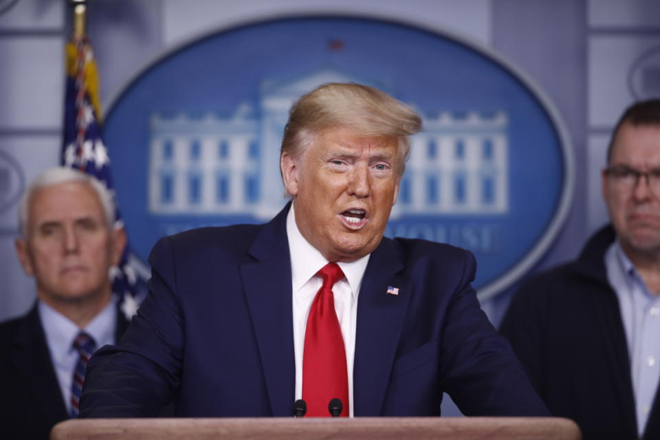 President Donald Trump speaks as Vice President Mike Pence, left, and FEMA Administrator Peter Gaynor look on, during a coronavirus task force briefing at the White House, Sunday, March 22, 2020, in Washington. (AP Photo/Patrick Semansky)